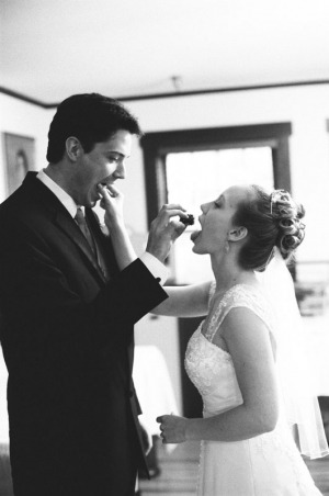 The Bride and Groom feed each other wedding cake