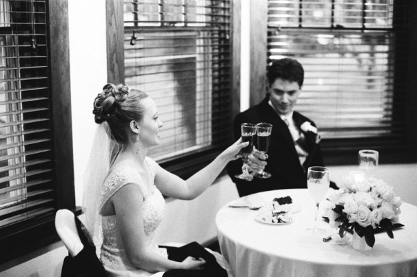 The Bride and Groom toast with champagne glasses