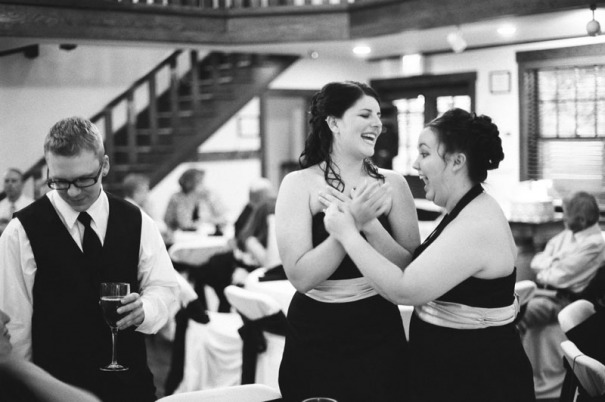 Two bridesmaids share a laugh