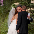 Bride and Groom hug the bride's father