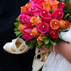 Bride holding her shoes and bouquet