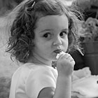 Flower girl looks over her shoulder